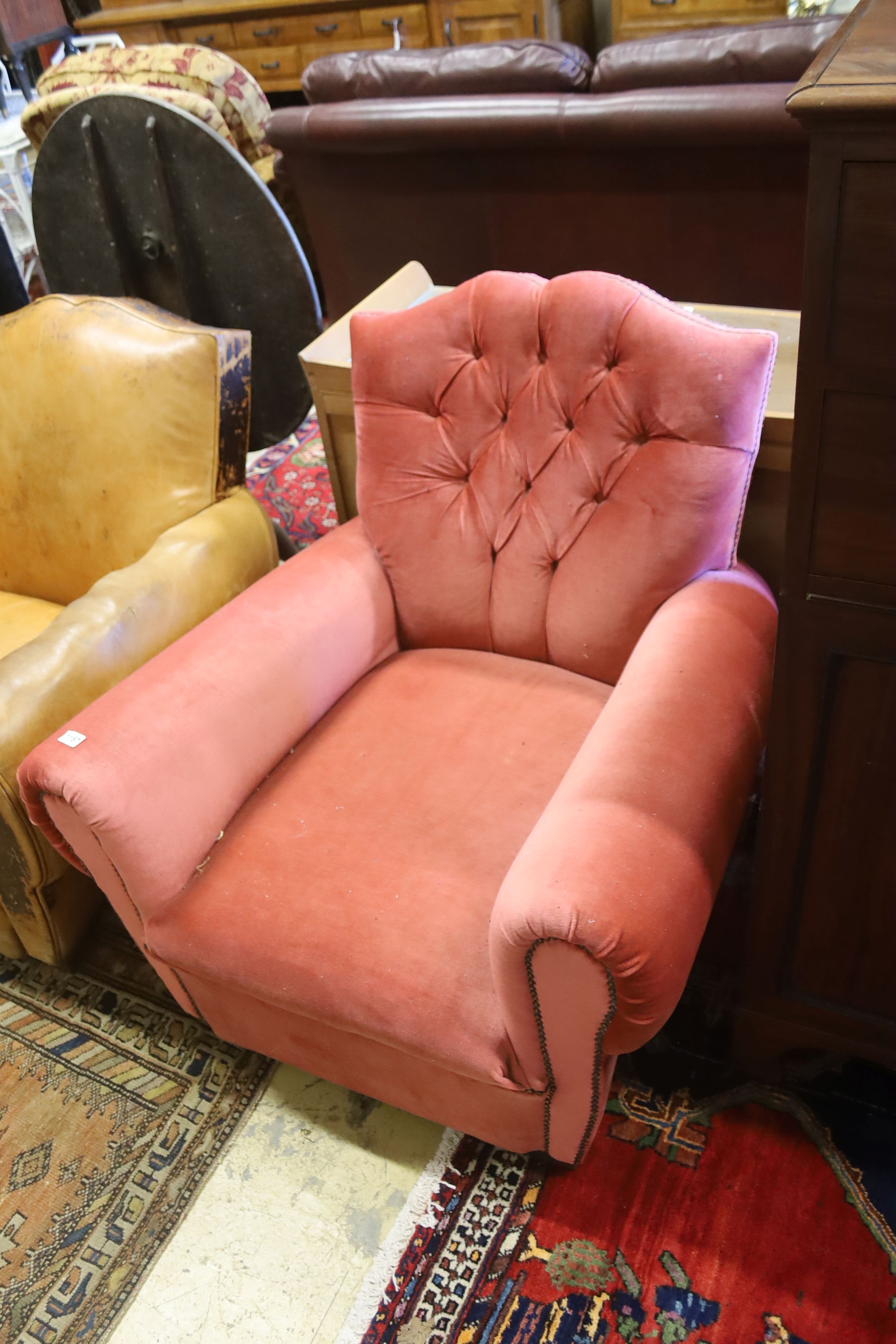 An early 20th century French armchair re-upholstered in pink dralon, width 86cm, depth 84cm, height 77cm